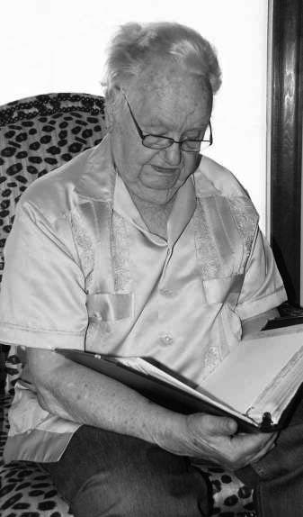 Green looks over some records of the missions he and his crew flew during the war.