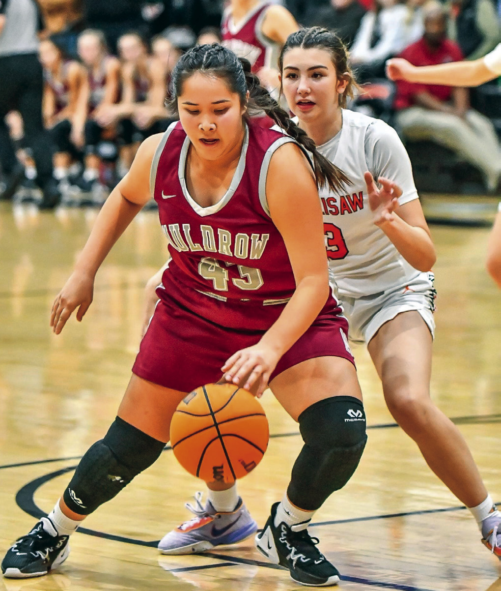 Muldrow senior Carmen Fields takes a defensive rebound from Sallisaw defender Molly Carver at Paul Post Field House during Friday’s 46-30 victory for the Lady Bulldogs. JIM CAMERON •TIMES