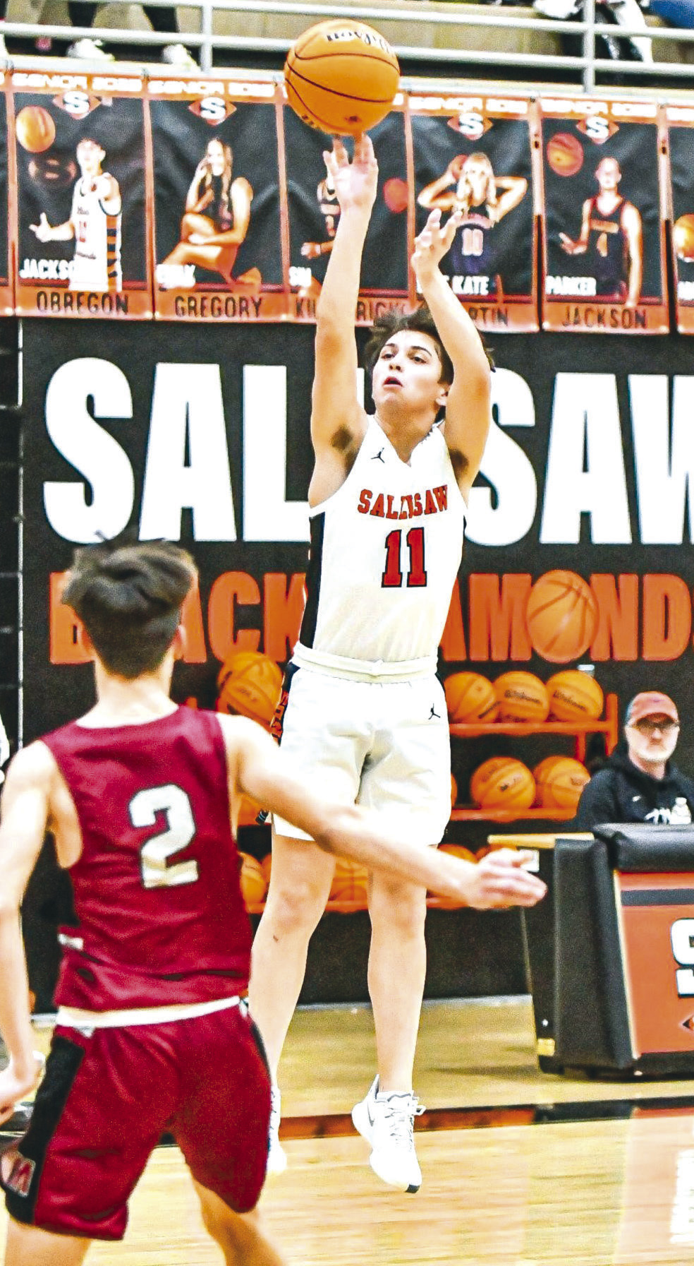 Sallisaw’s Jackson Obregon makes a three-pointer over the heads of Muldrow defenders during a classic cross-county Class 4A game Friday at Paul Post Fieldhouse in the Black Diamonds’ 62-56 loss. JIM CAMERON •TIMES