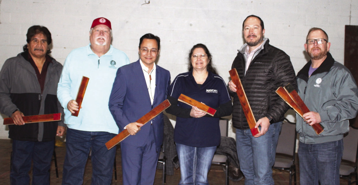 Cherokee Nation tribal officials and Marble City community representatives at kickoff ceremonies for the demolition of the old Marble City gym holding pieces of the old gym floor, which will be saved for the new community center, are (from left) Clifton Pettit, president of the food pantry organization; District 5 Cherokee Nation Councilman E.O. Smith; Cherokee Nation Principal Chief Chuck Hoskin; Marble City Mayor Tamara Hibbard; Cherokee Nation Deputy Principal Chief Bryan Warner; and District 5 Cherokee Nation Councilman Daryl Legg. LYNN MCCULLEY | TIMES