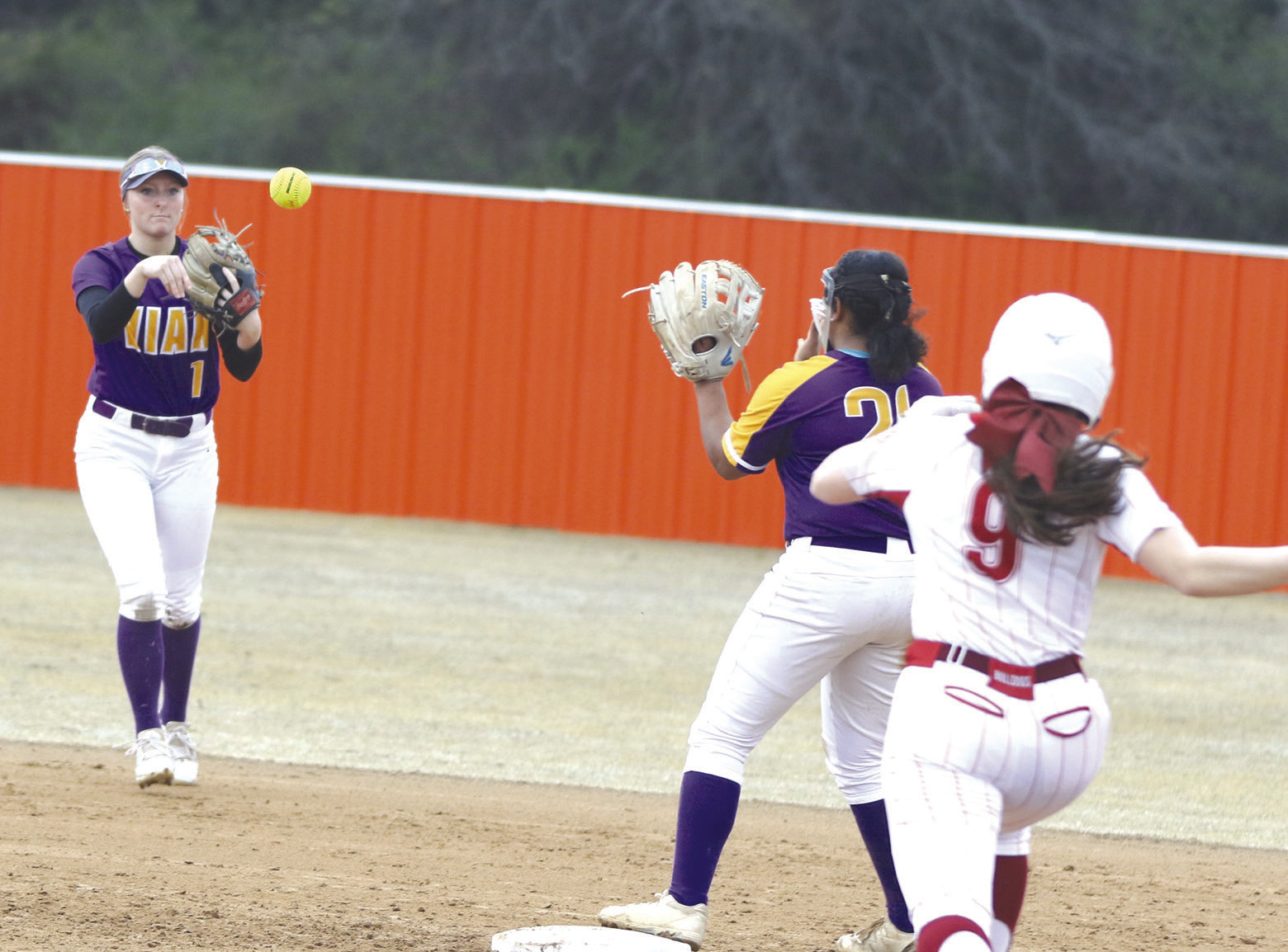 Vian shortstop Maisie Wells throws to second baseman LaKaila Drew to force out Muldrow baserunner Ashley Price during the Lady Wolverines’ Webbers Falls/Sallisaw Slowpitch Tournament opener Thursday at Sallisaw. The Lady Wolverines lost 11-2 to the eventual champion Lady Bulldogs in the contest. LEA LESSLEY •TIMES