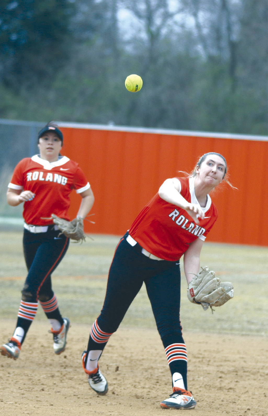 Roland third baseman Madi Mulanax throws to first base as shortstop Addyson Clark looks on during Thursday’s 11-4 win over Sallisaw in the Lady Rangers’ first game of the Webbers Falls/Sallisaw Slowpitch Tournament at Sallisaw. LEA LESSLEY •TIMES