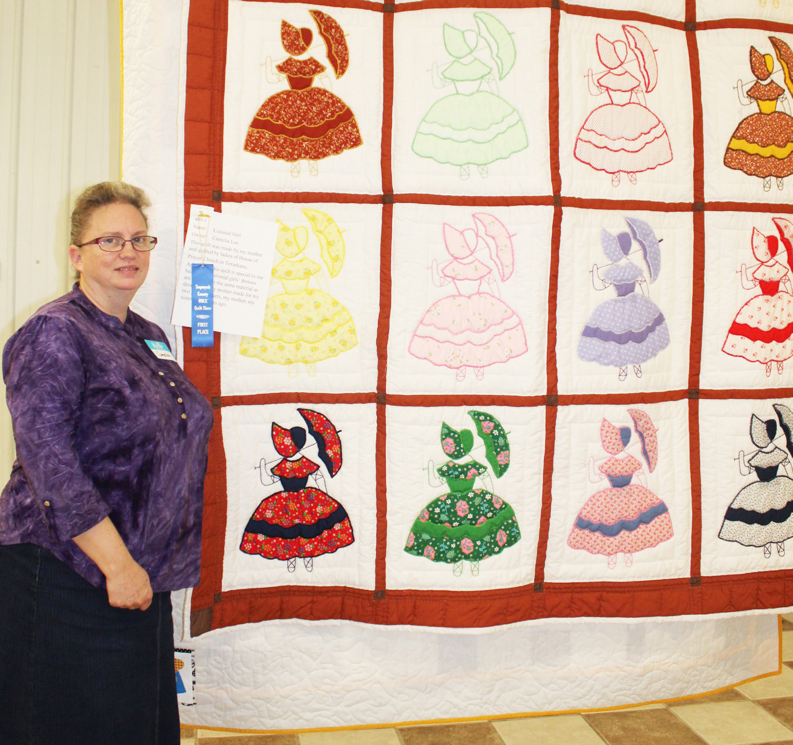 Camelia Lee is pictured with her antique quilt “Colonial Girl” which received a blue ribbon in this year’s annual OHCE Quilt Show. Lee said the quilt was made by her mother and quilted by the ladies of House of Prayer in Texarkana. “This quilt is special to me because the Colonial girls’ dresses are made from the same material as dresses that my mother made for my two grandmothers, my mother and my sister,” Lee said.