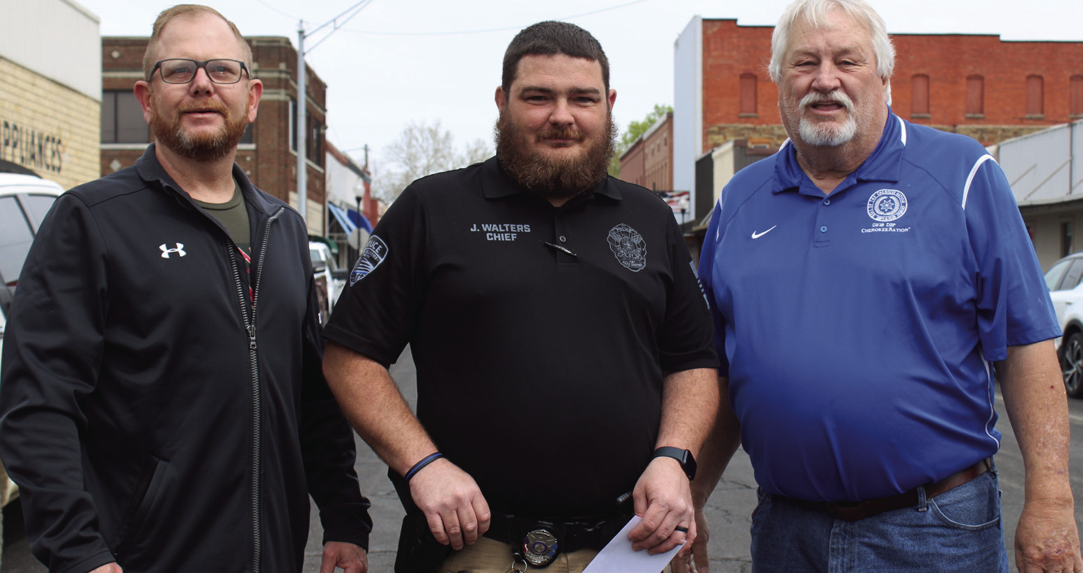 Gore Police Chief Jeremy Walters (center) receives a check for $10,000 from Cherokee Nation Dist. 6 Councilman Daryl Legg (left) and Dist. 5 Councilman E.O. Smith Jr. (right).