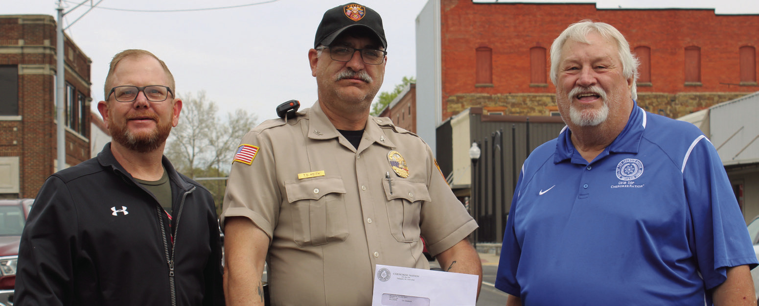 Muldrow Police Chief Tim Keith (center) receives a check for $10,000 from Cherokee Nation Council Representatives Daryl Legg (left), and E.O. Smith Jr. (right).