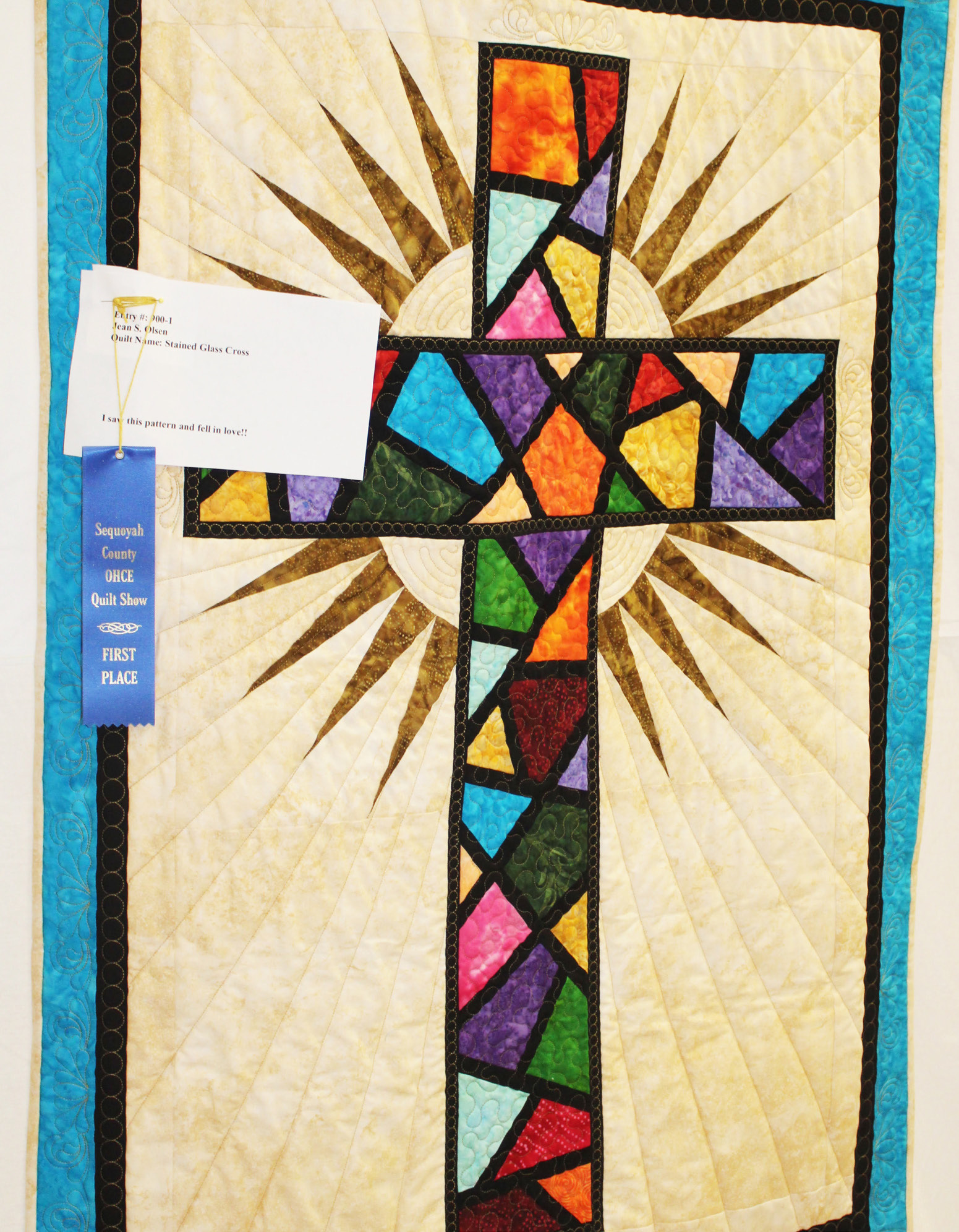 Stained glass cross received first place in the table runners, wall hangings and table topper division of the OHCE Quilt Show. Jean S. Olsen, who made the quilt, said she saw “this pattern and fell in love!”