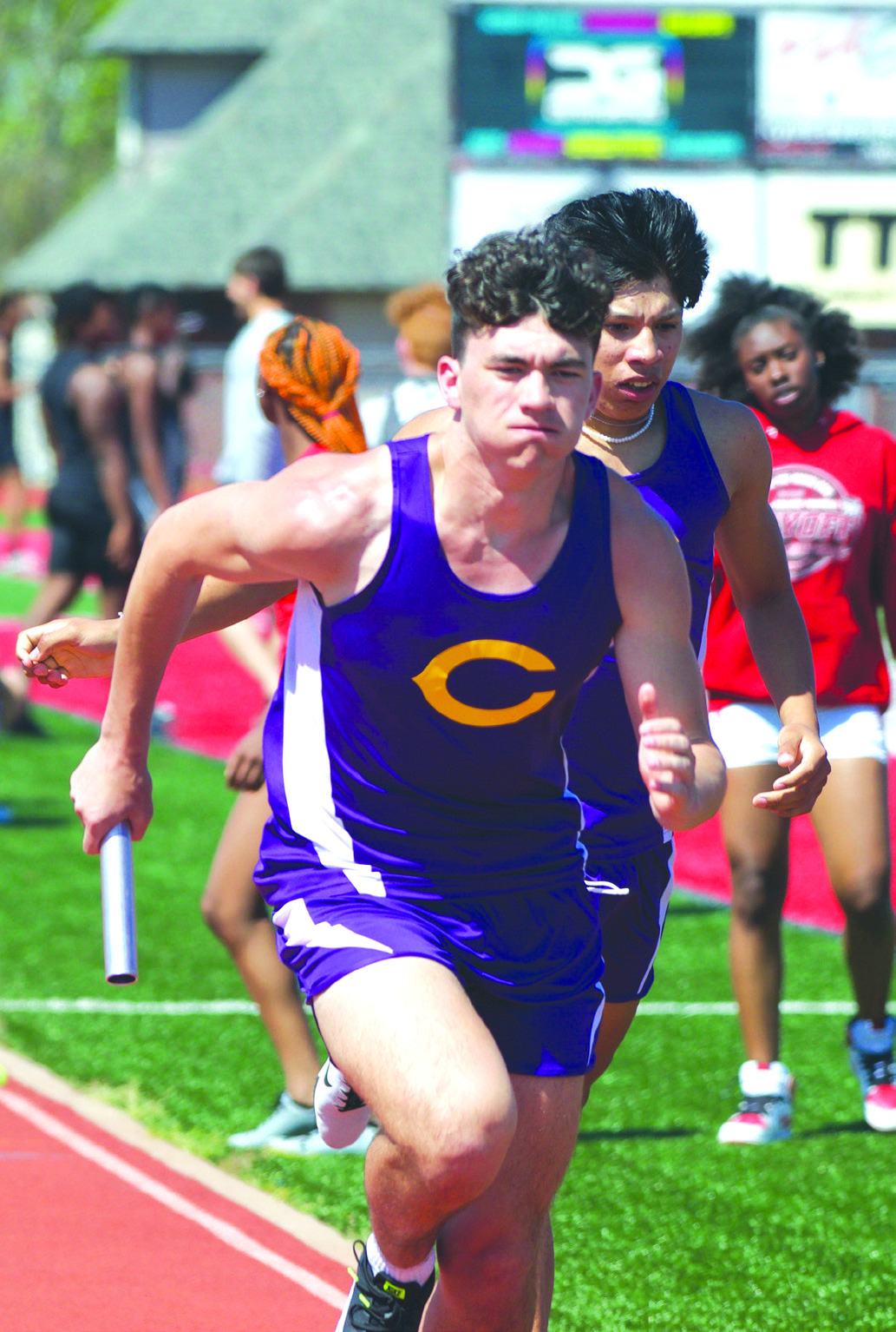 Central’s Nathan Vann (right) exits the track after giving the baton to Joseph Lee during the boys’ 4x400m relay at the recent Hilldale Hornet Track Meet. The Tigers will travel to Okemah Saturday for their Class 2A regional meet. LEA LESSLEY • TIMES