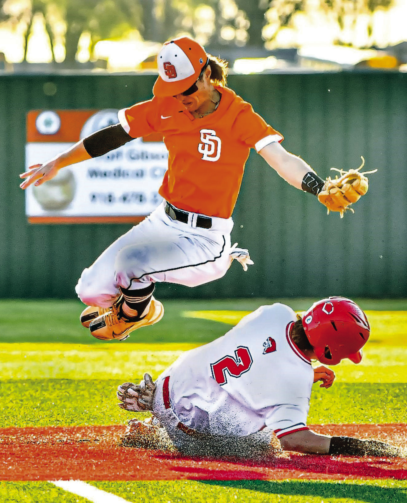 Black Diamond second baseman Tristan Wise-Potter leaps out of the way of a Fort Gibson runner Saturday at Carr-O’Dell Tiger Park in the championship game of the Fort Gibson/Hilldale Shootout tournament. JIM CAMERON • TIMES